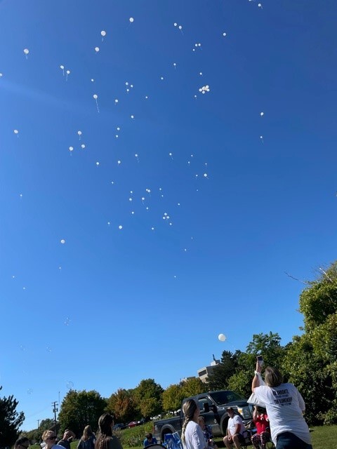 Hundreds of white balloons dotted the horizon at Rowden Park after being released following the Into the Light Suicide Awareness Memorial Ceremony.
