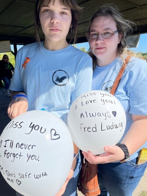 Allison Davis and Samantha Ruth, both of Lapeer, wrote memorial messages on their balloons released at the Into the Light Suicide Awareness Walk .