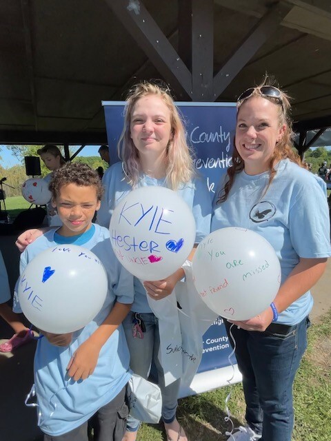 (Pictured left to right: Curtis Hampton, Courtney Tew and Nicole Prince) scribed messages onto their balloons later release at the Into the Light Suicide Awareness Walk